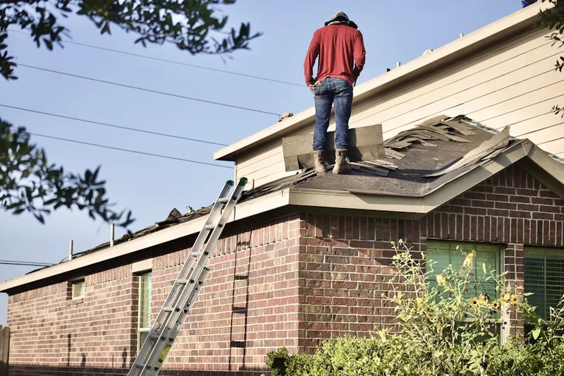 Professional roofer working on a residential roof in Odenton Park